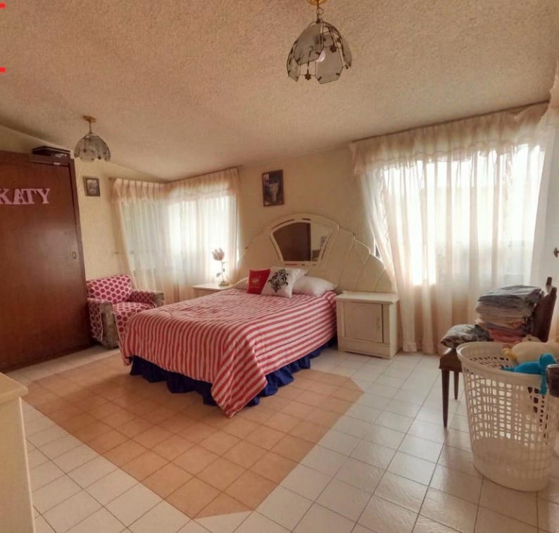 Segunda recámara con ventanales y cortinas claras